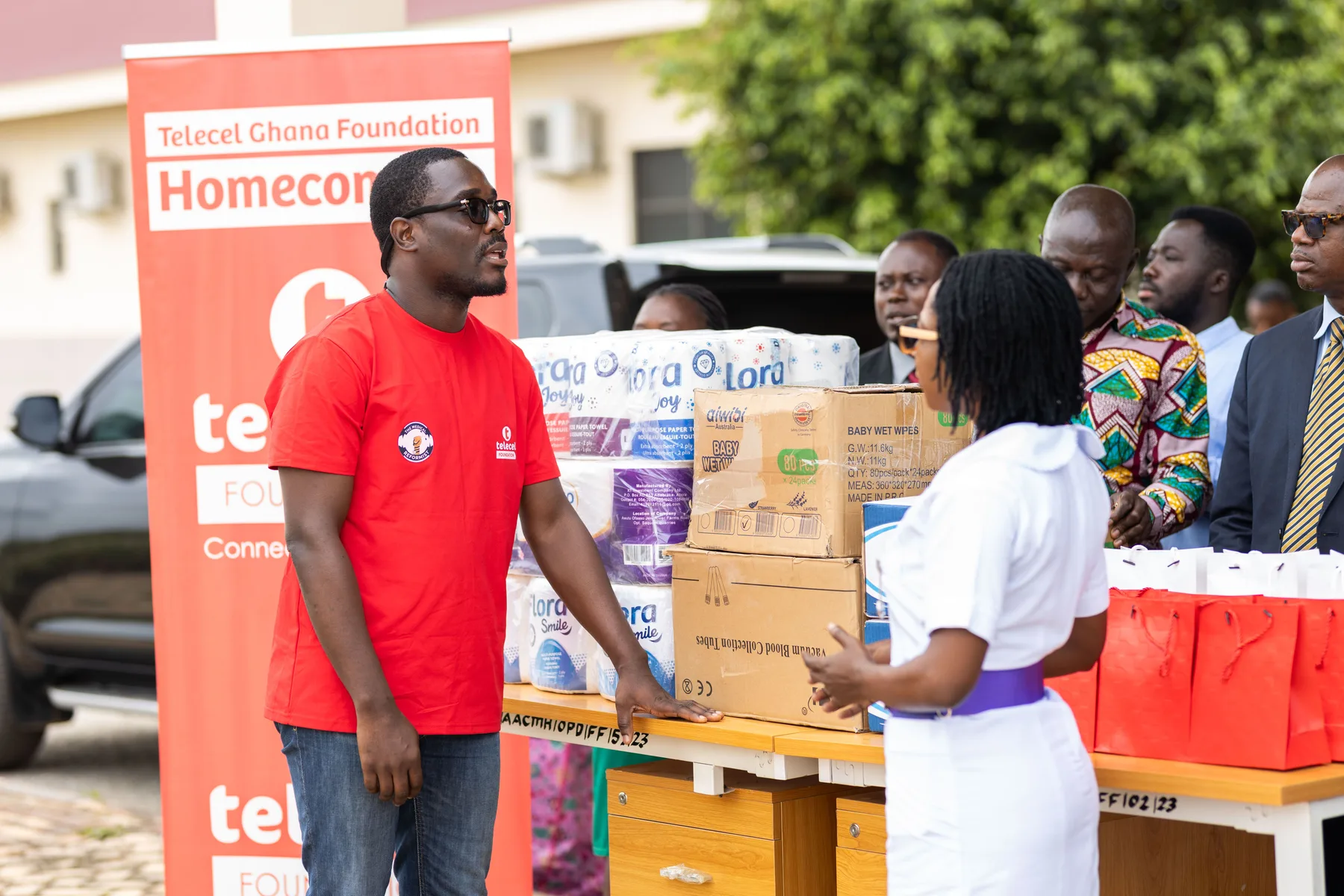 Black volunteers and community members at a humanitarian support event in Ghana