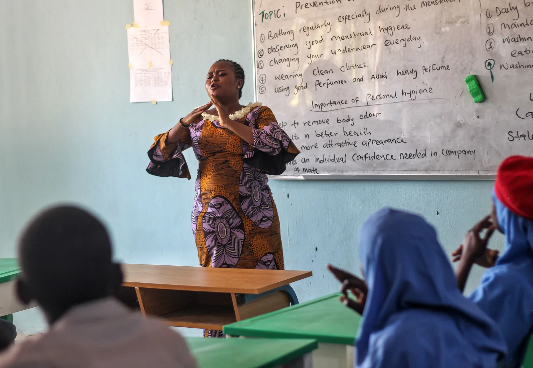 A Black health educator leading a practical hygiene lesson